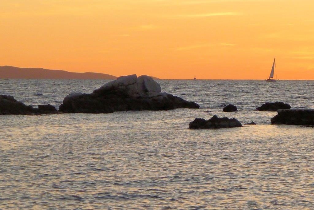 split sunset with sailboat