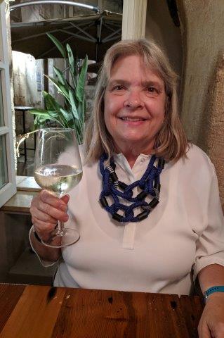 Susan holding a wine galss.